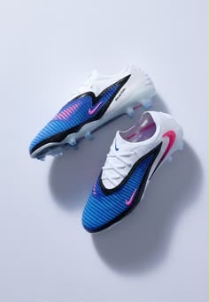 Pair of blue, white and pink firm-ground football boots
